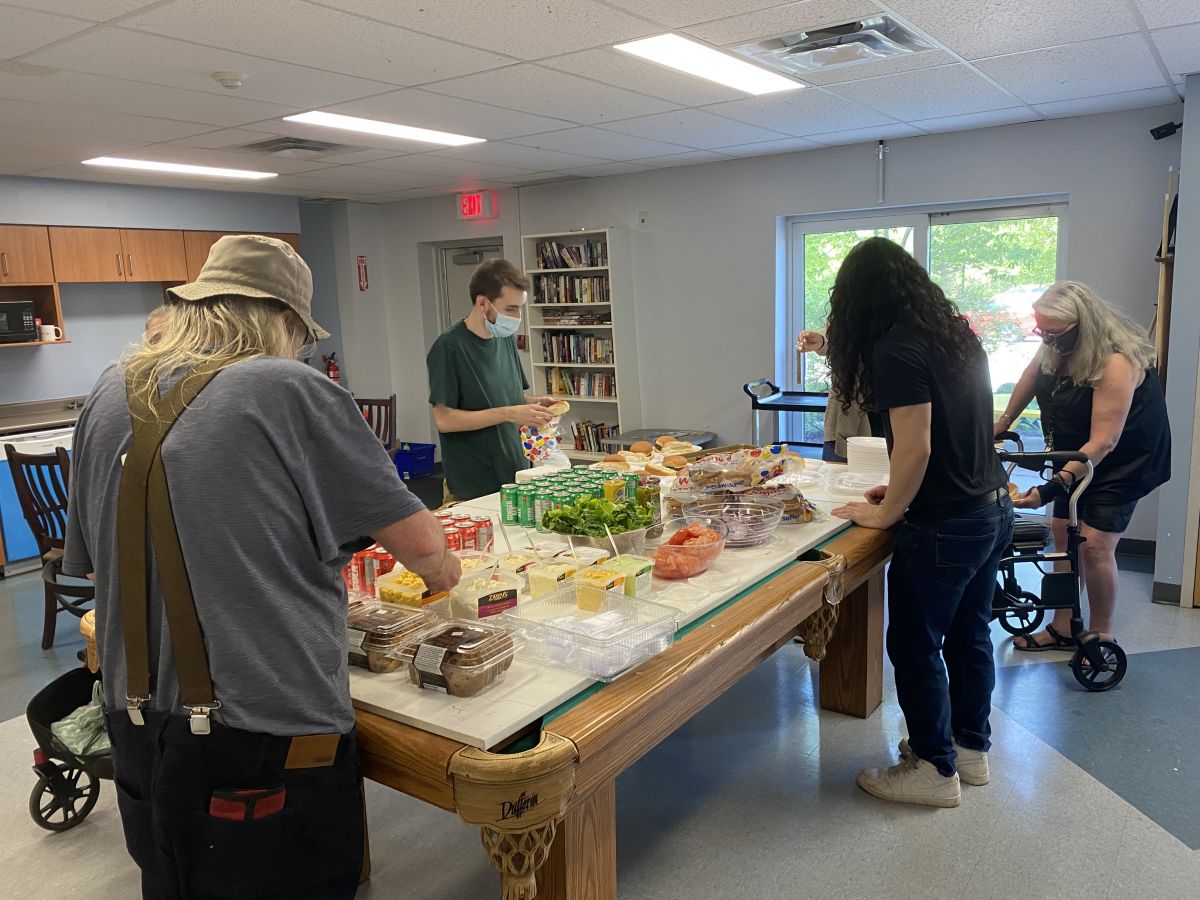 Residents, staff, and volunteers gather for a BBQ lunch!